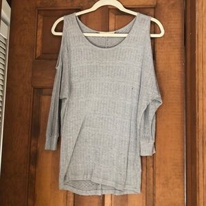 Long grey sweater with shoulder cutouts.